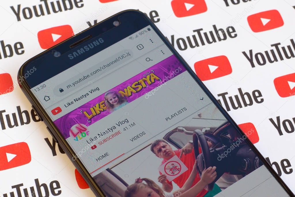 NY, USA - DECEMBER 4, 2019: Like Nastya Vlog official youtube channel on smartphone screen on paper youtube background.