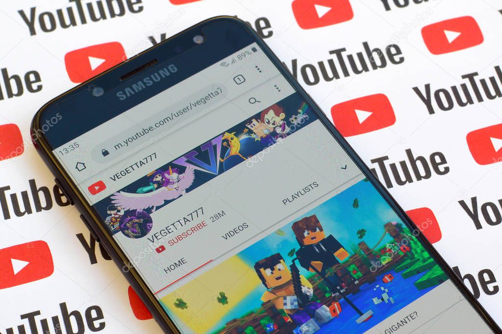 NY, USA - DECEMBER 4, 2019: Vegetta777 official youtube channel on smartphone screen on paper youtube background.