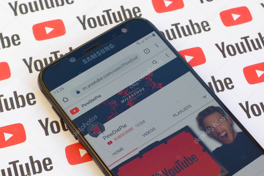 NY, USA - DECEMBER 4, 2019: Pewdiepie official youtube channel on smartphone screen on paper youtube background.