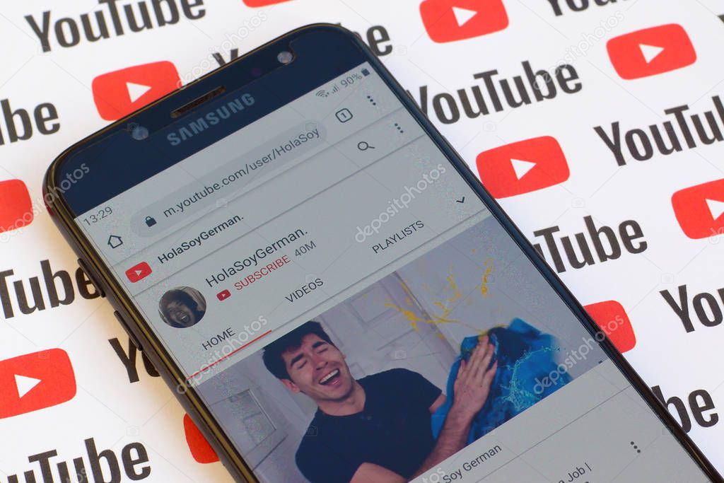 NY, USA - DECEMBER 4, 2019: HolaSoyGerman official youtube channel on smartphone screen on paper youtube background.