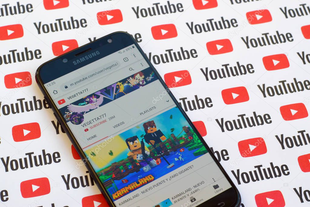 NY, USA - DECEMBER 4, 2019: Vegetta777 official youtube channel on smartphone screen on paper youtube background.