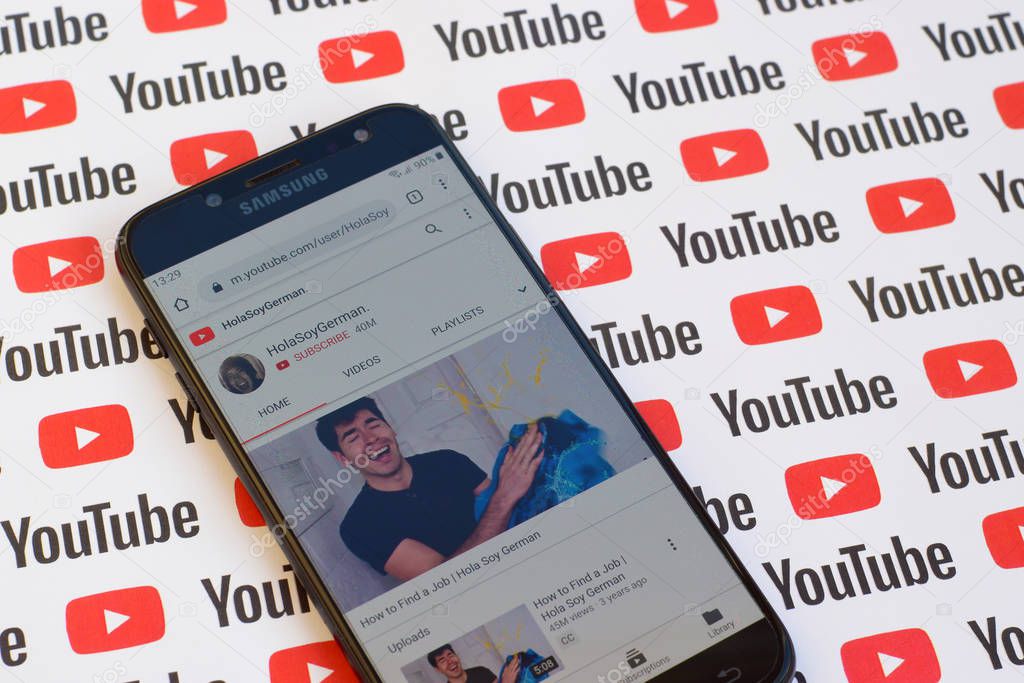 NY, USA - DECEMBER 4, 2019: HolaSoyGerman official youtube channel on smartphone screen on paper youtube background.