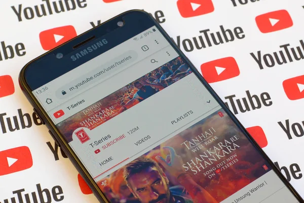 T-series official youtube channel on smartphone screen on paper — Stock Photo, Image