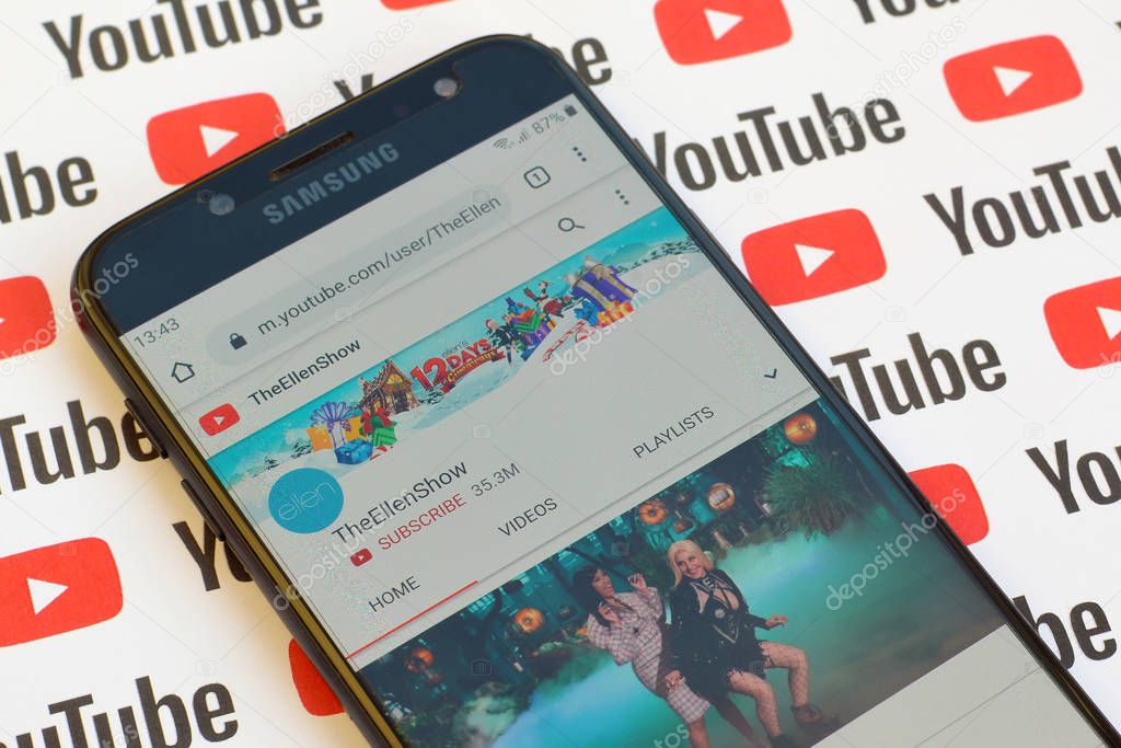 NY, USA - DECEMBER 4, 2019: TheEllenShow official youtube channel on smartphone screen on paper youtube background.