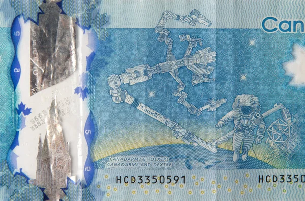 Dextre and canadarm2 on Canada 5 Dollars 2013 Polymer Banknote fragment — Stock Photo, Image