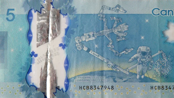 Dextre and canadarm2 on Canada 5 Dollars 2013 Polymer Banknote fragment — Stock Photo, Image