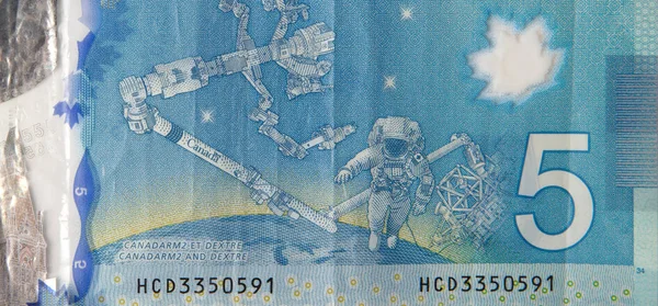 Dextre and canadarm2 on Canada 5 Dollars 2013 Polymer Banknote fragment — Stock Photo, Image