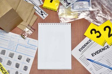 Paperwork during crime scene investigation process in csi laboratory. Evidence labels with fingerprint applicant and many confiscated personal items on wooden table clipart