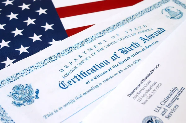 Fs-545 Certification of birth abroad lies on United States flag with envelope from Department of Homeland Security — Stock Photo, Image