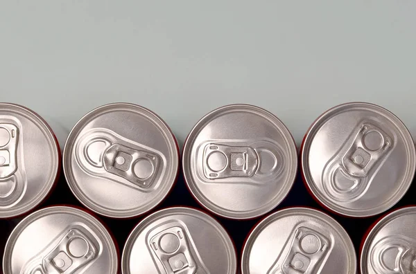 Many new aluminium cans of soda soft drink or energy drink containers. Drinks manufacturing concept and mass production — 스톡 사진