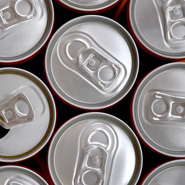 Many cans of soda soft drink or energy drink containers. A lot of recycled cans made from aluminum and being prepared for re-production. — Stock Photo, Image