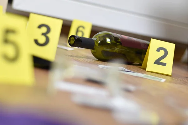 Olay yeri inceleme sırasında kırık cam ve şarap şişesi kanıt olarak işaretlenmiş. Sayılı bir sürü sarı işaret — Stok fotoğraf