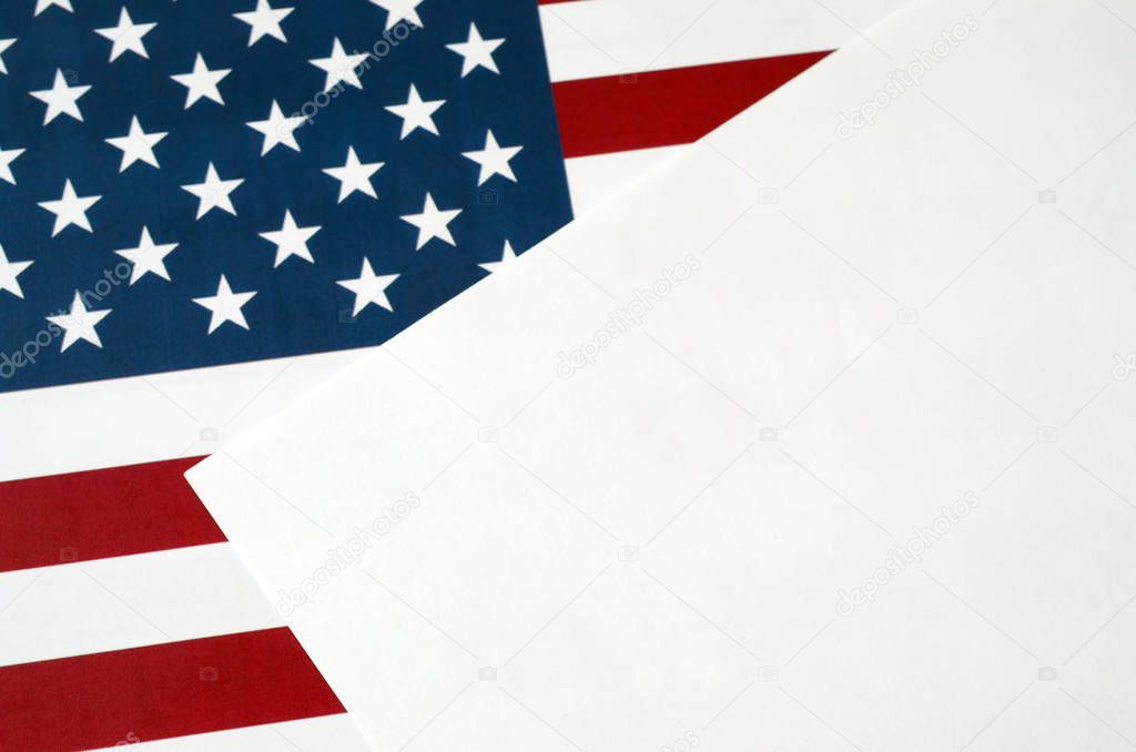 Empty blank a4 paper document on United States flag close up. Template for design with US flag