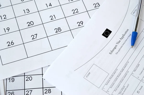 Schengen Visa application form and blue pen on paper calendar page — 스톡 사진