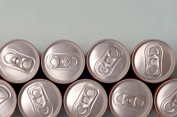 Many new aluminium cans of soda soft drink or energy drink containers. Drinks manufacturing concept and mass production — 스톡 사진