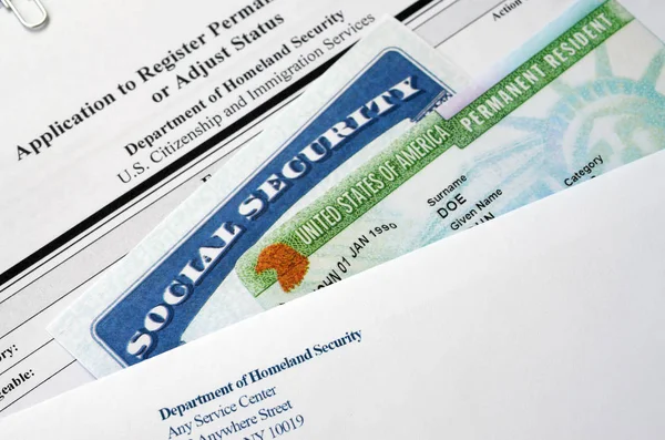 I-485 Application to register permanent residence or adjust status form and green card from dv-lottery with social security number lies with USCIS envelope — Stock Photo, Image