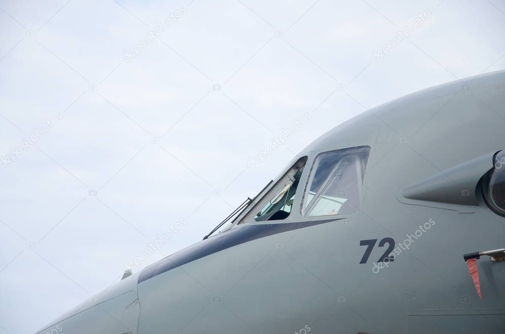 Cabin of armoured military aircraft close up against blue sky