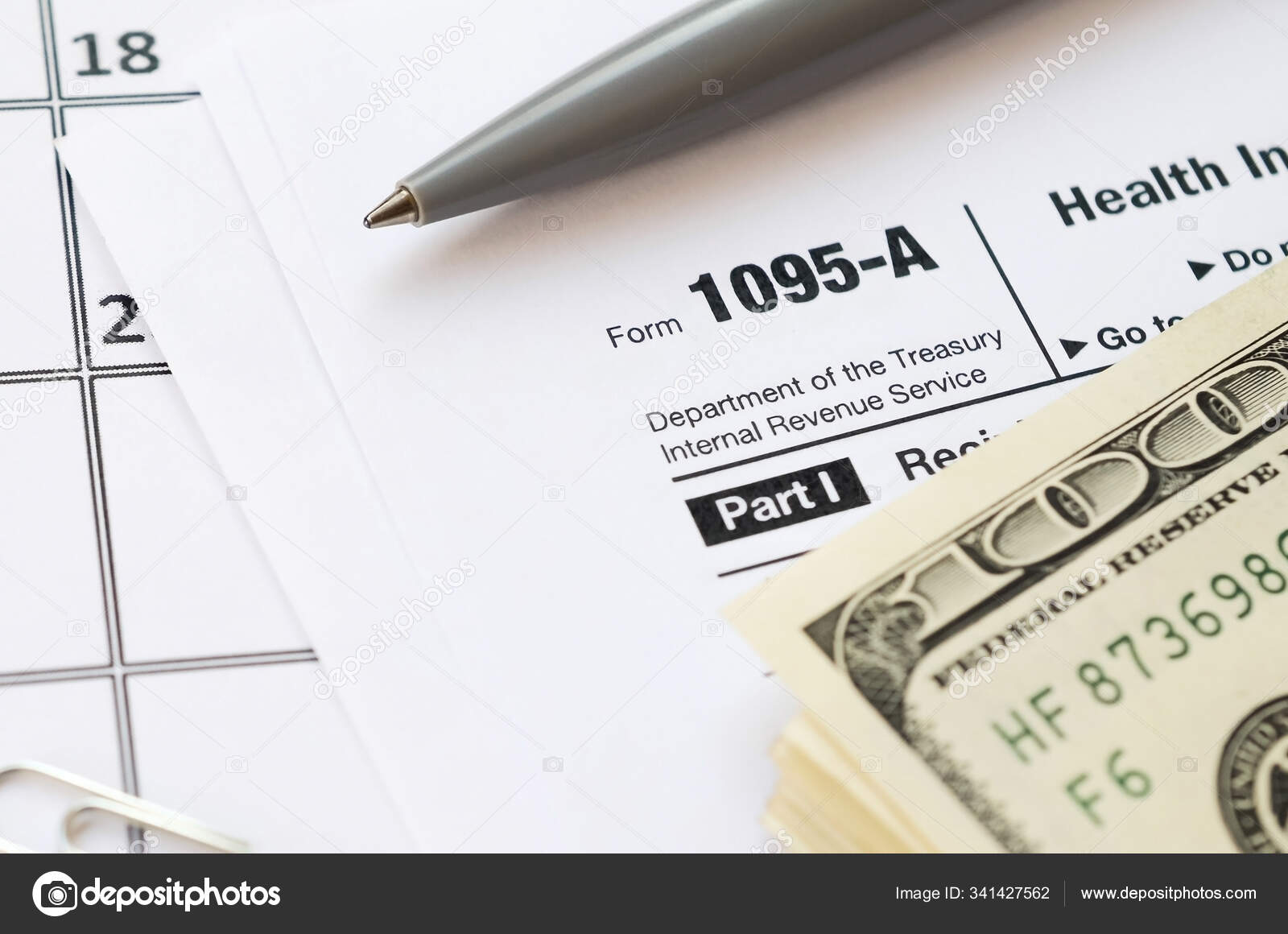 irs-form-1095-a-health-insurance-marketplace-statement-tax-blank-lies-with-pen-and-many-hundred-dollar-bills-on-calendar-page-stock-photo-mehaniq-341427562