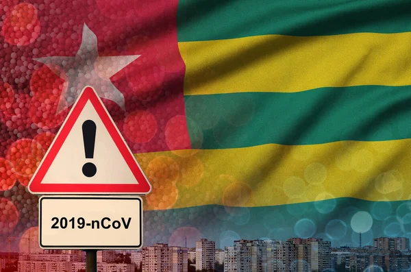 Togo flag and Coronavirus 2019-nCoV alert sign. Concept of high probability of novel coronavirus outbreak through traveling tourists