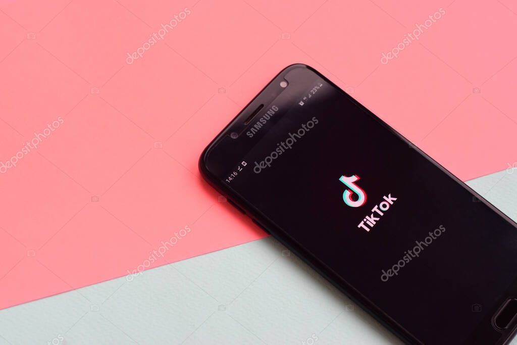 KHARKOV, UKRAINE - FEBRUARY 16, 2020: Tiktok application on samsung smartphone screen on pastel background. TikTok is a popular video-sharing social networking service owned by ByteDance