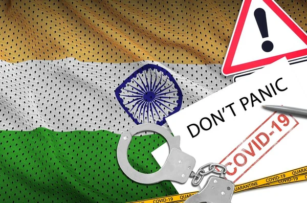 India flag and police handcuffs with inscription Don\'t panic on white paper. Coronavirus or pandemic 2019-nCov virus concept