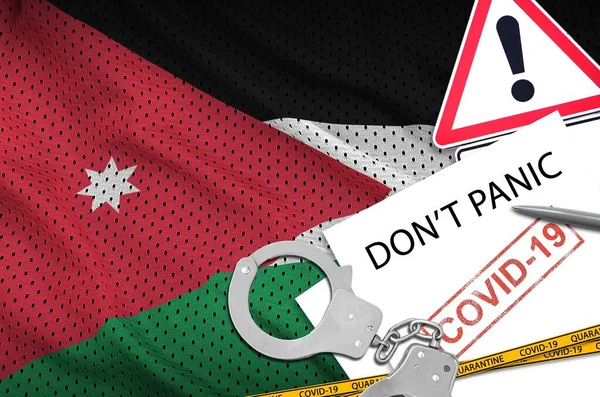 Jordan flag and police handcuffs with inscription Don\'t panic on white paper. Coronavirus or pandemic 2019-nCov virus concept
