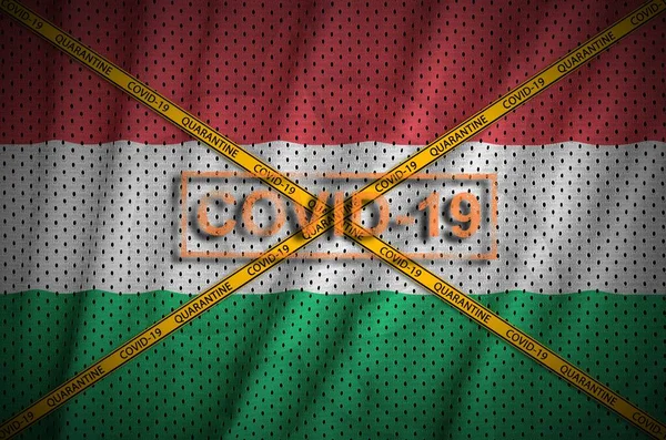 Hungary flag and Covid-19 stamp with orange quarantine border tape cross. Coronavirus or pandemic 2019-nCov virus concept
