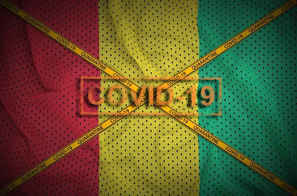 Guinea Flagga Och Covid Stämpel Med Orange Karantän Gräns Tejp — Stockfoto