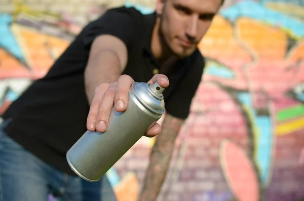 Young Graffiti Artist Aims His Spray Can Background Colorful Graffiti — Stock Photo, Image