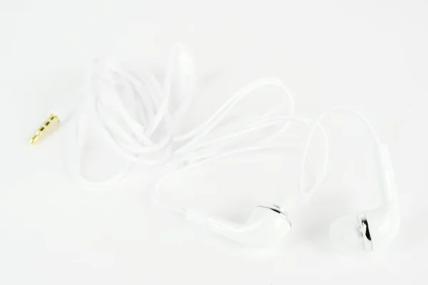 Белый наушник для устройства с белым кабелем — стоковое фото
