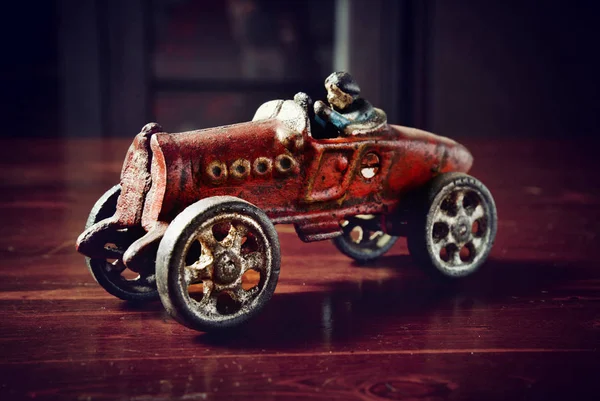 Rotes Oldtimer-Spielzeugauto auf dunklem Holztisch — Stockfoto