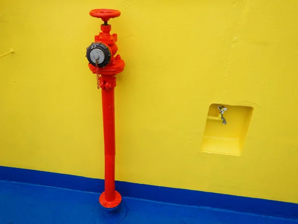 red fire hose connection on ferry boat deck
