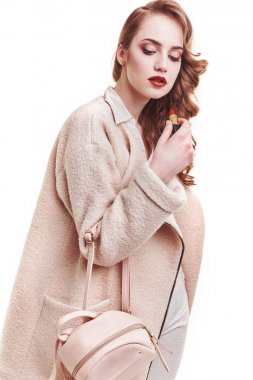 Sarışın kadın stüdyoda poz güzel kıyafetler moda. Ceket, çanta, yüksek topuklu sandalet giyiyor. Bahar Yaz fotoğraf