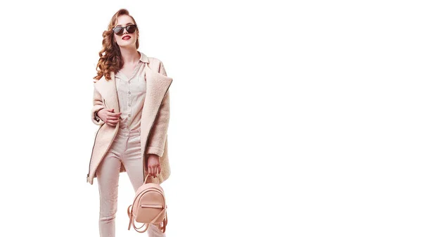 Kadın stil ve moda giysiler. Kadın modeli şık moda giyim pembe ceket, beyaz arka plan üzerinde mor sırt çantası çanta ışık. Güzel kız portre Studio poz. Yüksek çözünürlük