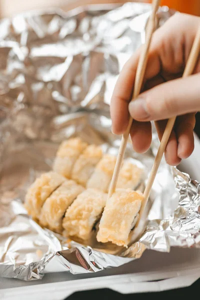 Japon yemek servisi plastik kutuda ve folyoda, sıcak ve fırında rulo, yemek teslimatı karantina evi fast food öğle yemeği suşisi