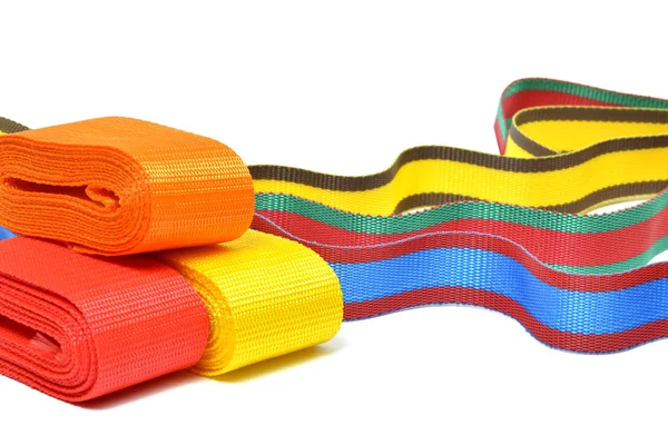 Multicolored top cord ribbons waving on white background — Stock Photo, Image