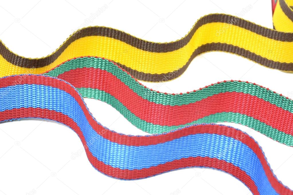 Multicolored top cord ribbons waving on white background