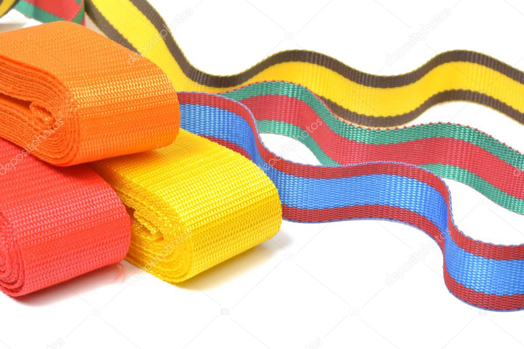 Multicolored top cord ribbons waving on white background