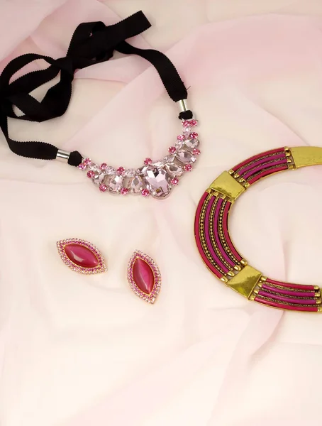 Fashion jewelry advertisement - bijouterie on pink kerchief — Stock Photo, Image