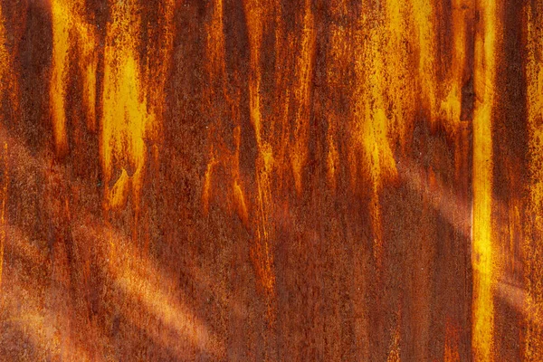 Texture of iron metal painted multicolored red yellow peeling paint of old battered scratched cracked ancient rusty metal sheet wall with corrosion. The background — Stock Photo, Image