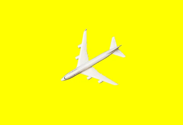 White plane, airplane in yellow color. Rainbow gradient background with copy space. Top view, flat lay. Minimal style design. Travel, vacation concept. Banner — 스톡 사진