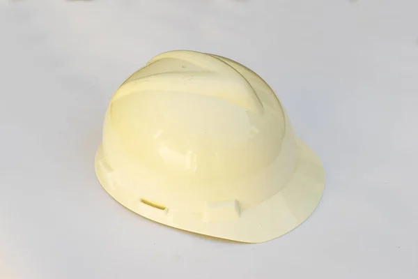 Plastic hard white safety helmet on white background.