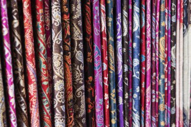 Oriental, Turkish, Indian multi-colored women's silk headscarves handmade on shop window for sale.