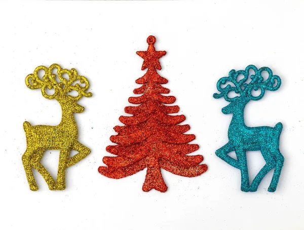 Multicolored Christmas reindeer and Christmas trees on a white background. — 스톡 사진