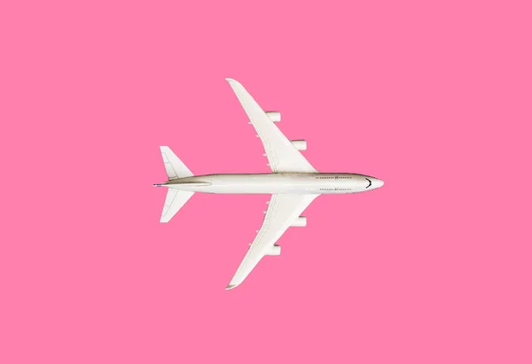 Model plane, airplane on pink pastel color background with copy space.Flat lay design.Travel concept on pink background. top view model plane on pink color background.