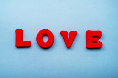 The word Love is made up of red letters on a blue background.