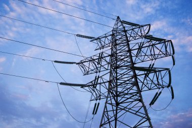 High voltage post or High voltage tower. Power line, insulators and wires. high voltage power pylons against blue sky and sun rays. Green energy concept, Electricity station, Close up high voltage
