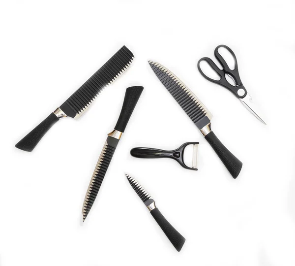 Black kitchen ceramic knives and scissors on a white background