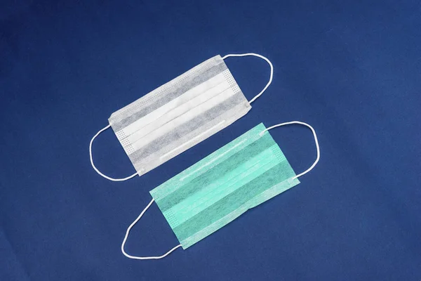 Medical mask protective , mask on blue background disposable surgical face mask cover the mouth and nose mask medical healthcare and medical for protect against viruses covid 19 Coronavirus or dust.