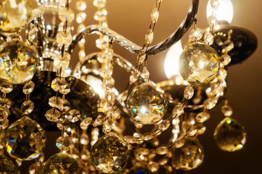 Tavandan sarkan ampullü kristal bir avize..